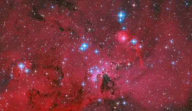 NASA's Hubble captures a crimson stellar nursery sparkling with blue and white stars