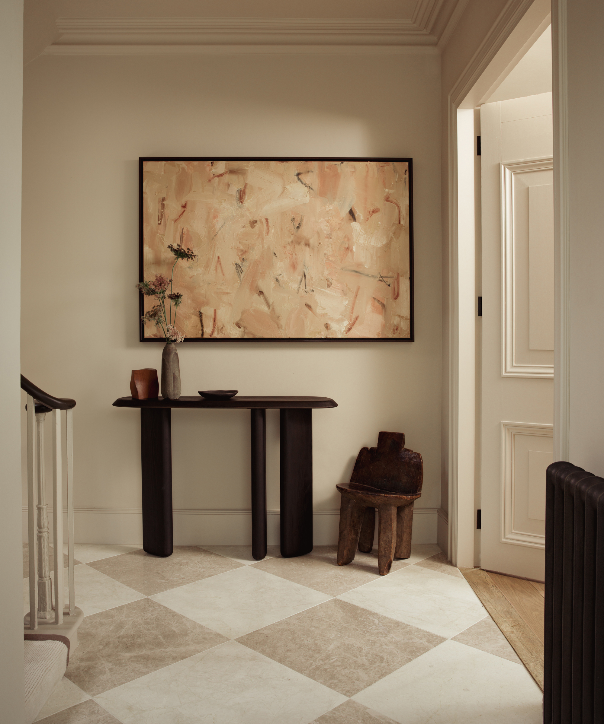 entryway with checkerboard floor and art on the walls