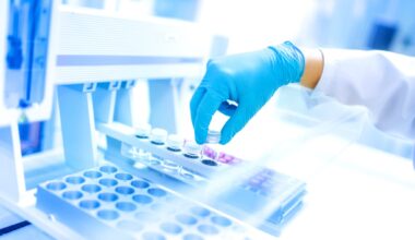 Scientist using protective robber gloves for handling substances and experiments
