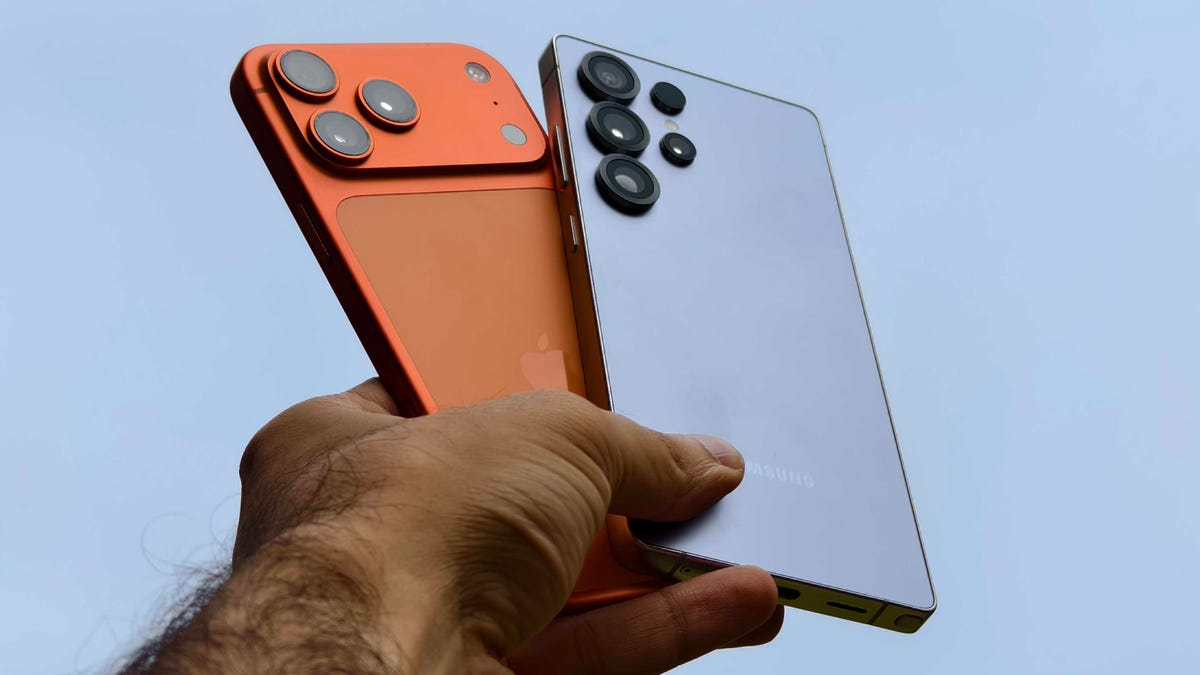 Prakhar Khanna holding the iPhone 17 Pro Max and Galaxy S25 Ultra.
