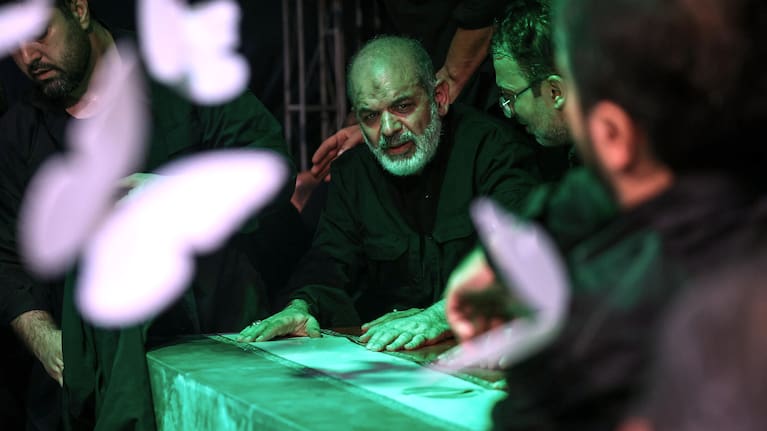 In this photo released by Iran's Supreme Leader's office, Iran's paramilitary Revolutionary Guard Gen. Ahmad Vahidi sits alongside Iran's Supreme Leader Ayatollah Ali Khamenei's casket.
