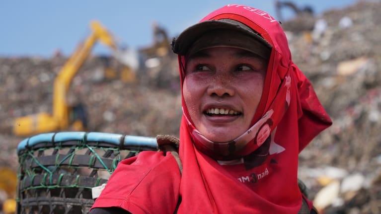 Nur Wencih, a waste picker, walks past at the Bantargebang landfill.