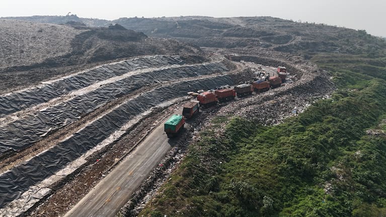 Garbage trucks line up before unloading waste at the Bantargebang landfill.