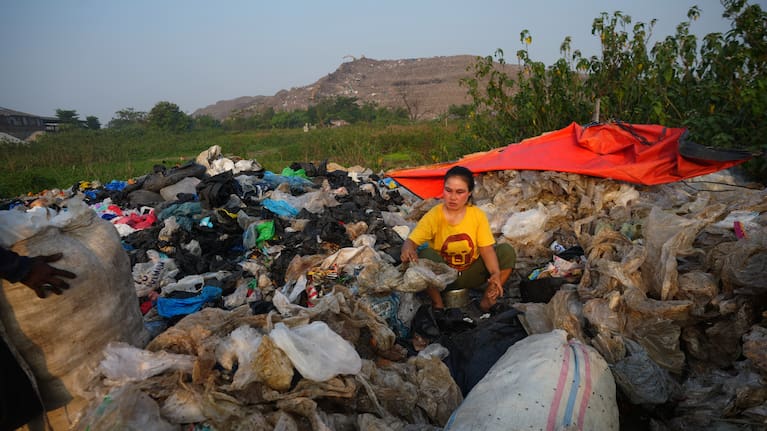 Nur Wencih, a waste picker, sorts recyclable items of her boarding house near the Bantargebang landfill.