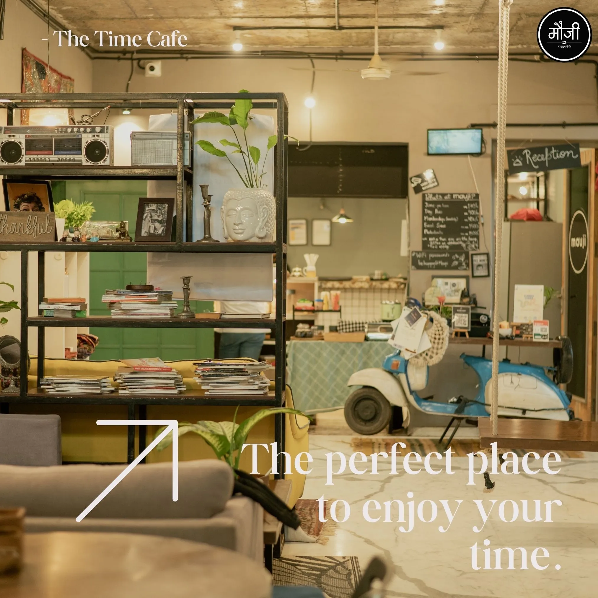 Interior view of Mauji Time Cafe featuring cozy seating, bookshelves, indoor plants, vintage décor, and a reception area