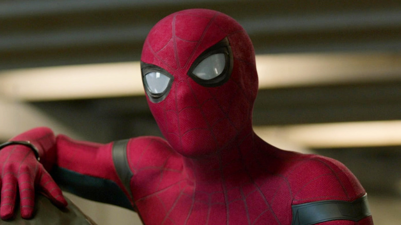 Tom Holland as Peter Parker cocking his head in his Spider-Man suit in Spider-Man: Homecoming