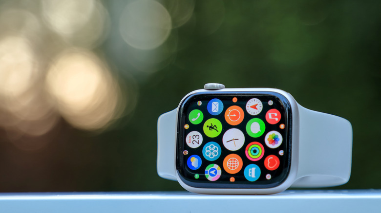 An Apple Watch placed on its side on a flat surface.