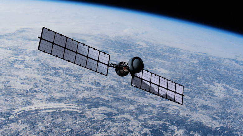 Artist's rendering of a satellite in orbit over the Earth.