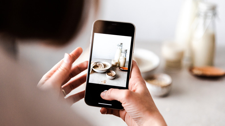 a person taking a photo of food with a smartphone camera