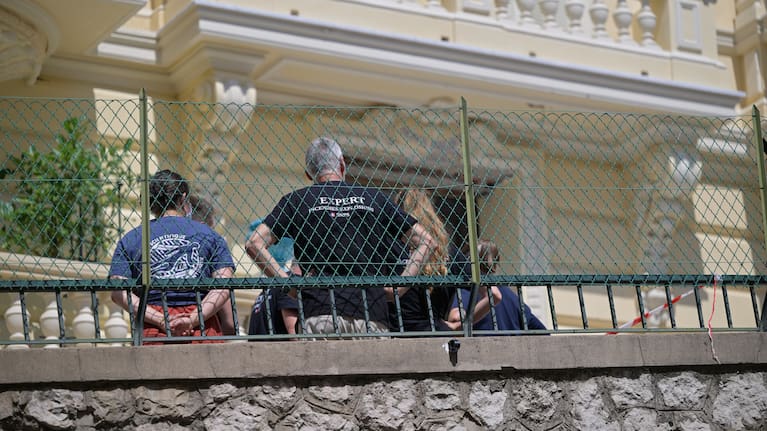 Investigators examine the scene at the residential building where an explosive device seriously injured three people a day earlier in Monaco, Tuesday, June 30, 2026.