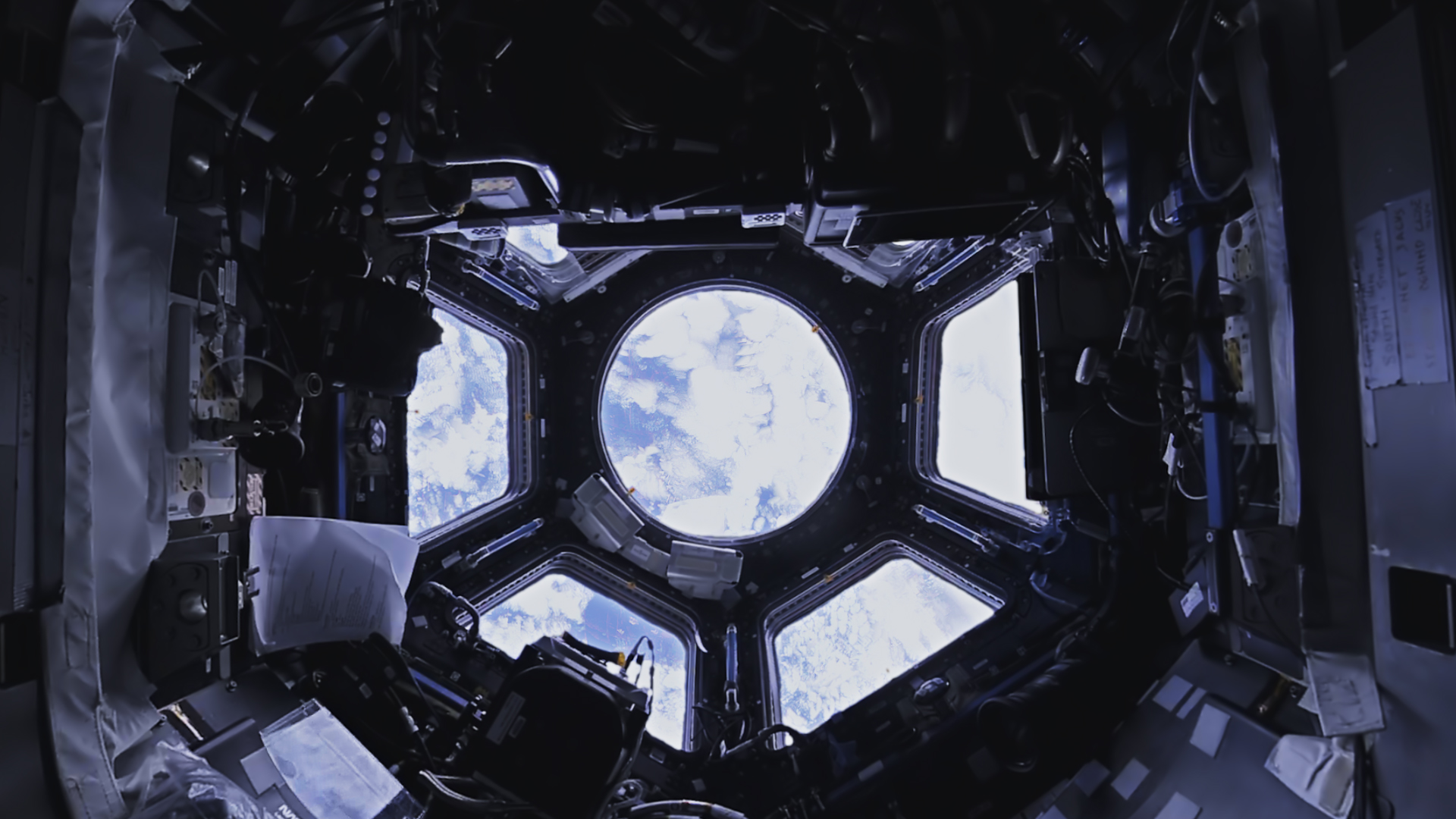 A view of the cupola. Through the windows, you can see the Earth.