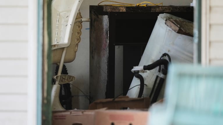 Items including a high chair, left, are seen in a home where authorities say they removed 16 children and arrested four adults in Hamden, Ohio, Wednesday, July 1, 2026.