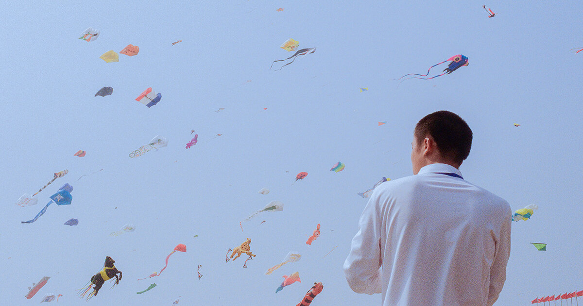 beneath a kite-filled sky, janice chan photographs tropical fish and noodle packets