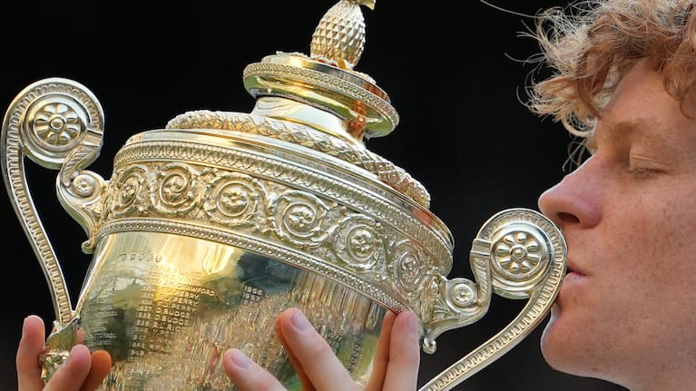 Jannik Sinner of Italy kisses the winners trophy after defeating Alexander Zverev of Germany in the men's singles final at Wimbledon Tennis Championships in London.