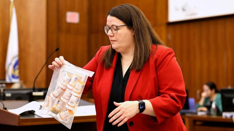 Jennifer Sprague, a prosecutor with the Plymouth County District Attorney's Office, enters a bag of prescription pills as evidence in Lindsay Clancy's trial. (Source: Greg Derr/The Patriot Ledger via AP, Pool)