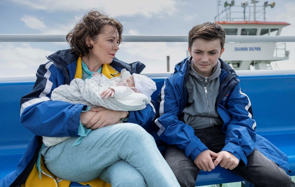 Olivia Colman in Joyride olivia colman in joyride, sat on a bench next to charlie reid and holding a baby
