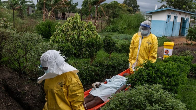 Medical staff carry an Ebola patient to a treatment centre in Rwampara, Congo.