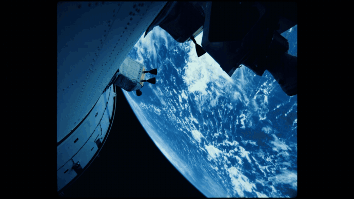 a gif of Artemis II rotating above the earth