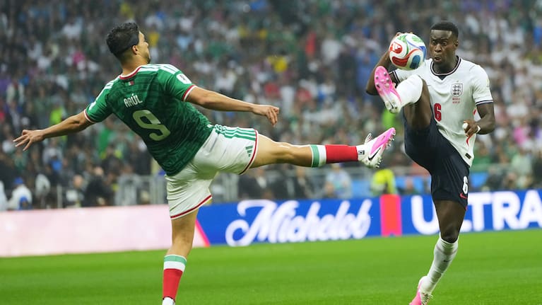 Mexico's Raul Jimenez, left, and England's Marc Guehi challenge for the ball