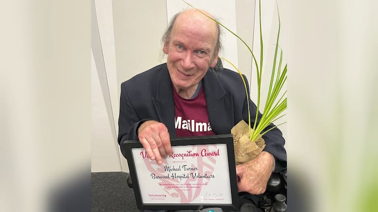 Michael Turner shows off an award received during Volunteer Week.