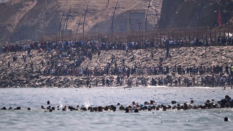Migrants cross from Morocco into the Spanish enclave of Ceuta.