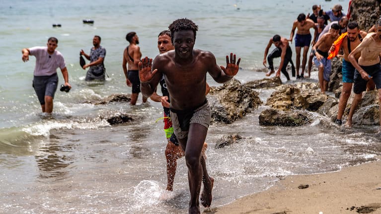 Migrants cross from Morocco into the Spanish enclave of Ceuta.