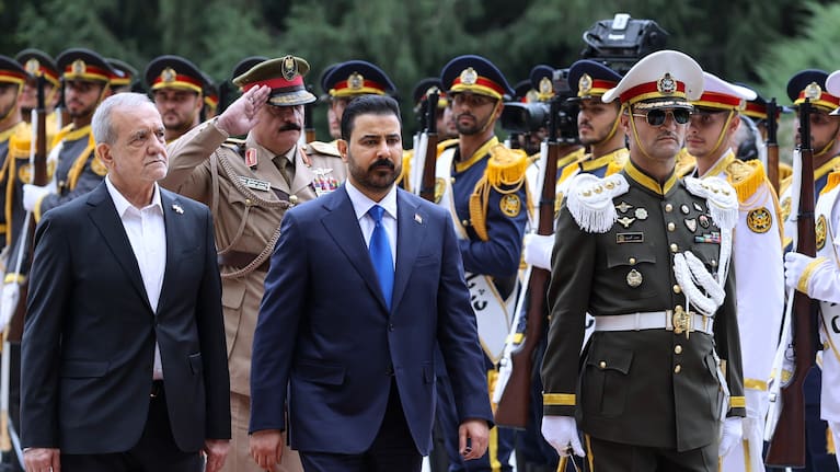 n this photo released by the Iranian Presidency Office, Iraq's Prime Minister Ali al-Zaidi, center, reviews an honor guard as he is welcomed by the Iranian President Masoud Pezeshkian.