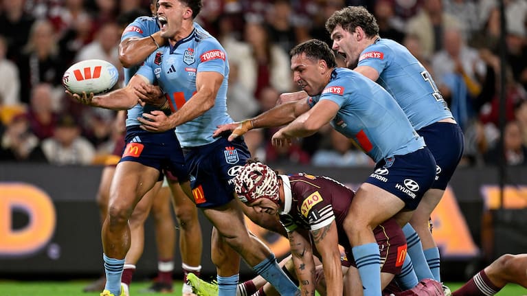 Nathan Cleary of the Blues (left) celebrates with teammates after scoring a try during Game 3 of the 2026 State of Origin between the Queensland Maroons and NSW Blues at Suncorp Stadium in Brisbane, Wednesday, July 8, 2026.