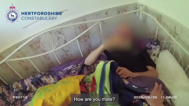 On moving the bag, the officer found there was a man hidden underneath.
