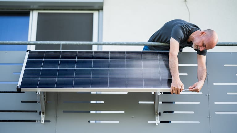 One mature man adjusting solar panel on balcony of his house (File image).