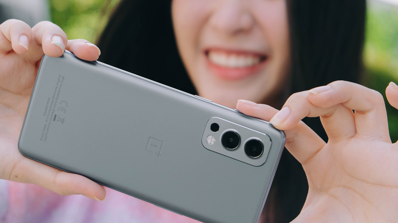 a woman taking a photo with a OnePlus phone camera