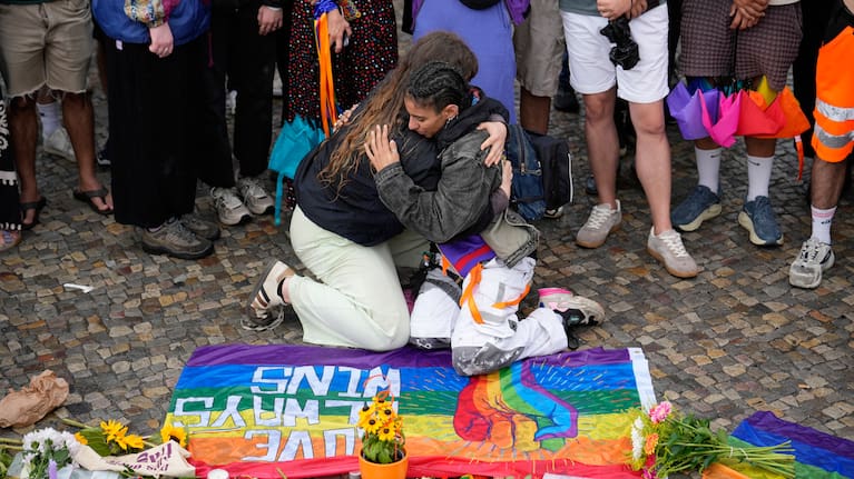 People gather outside the Brandenburg Gate for a demonstration in support of LGBTQ+ after a car rammed into a crowd at the Pride March in Berlin.