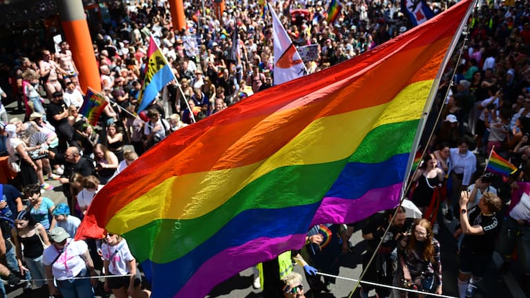 People march with a rainbow flag during the Christopher Street Day parade in Berlin, on Saturday, July 25, 2026.