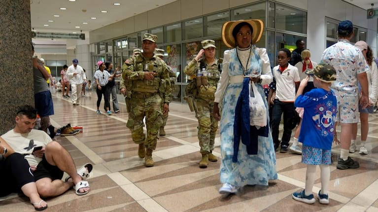 People take cover in the Ronald Reagan Federal Building after evacuating the National Mall due to weather.