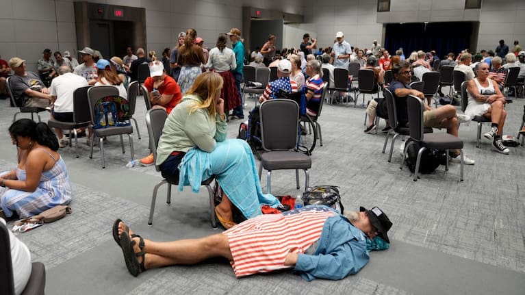 People take cover in the Ronald Reagan Federal Building after evacuating the National Mall due to weather.