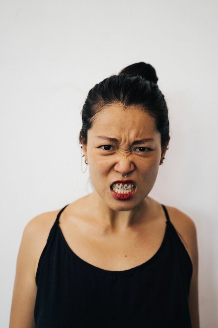 An angry woman with a nose ring and bared teeth, portraying the frustration ER staff face with patients.