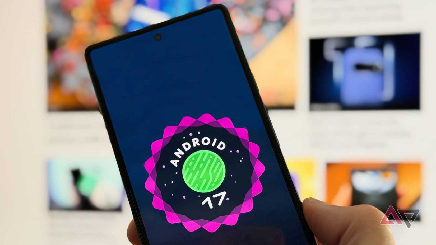 A hand holding a Google Pixel 6 showing the Android 17 logo.