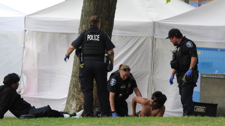 Police attend to a person after a shooting at Seattle Center during the Bite of Seattle food festival Sunday, July 26, 2026, in Seattle.