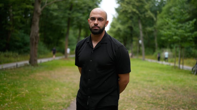 Police officer Ali Darwich poses for a portrait near the scene where a car rammed into a crowd at the Pride March in Berlin, Germany