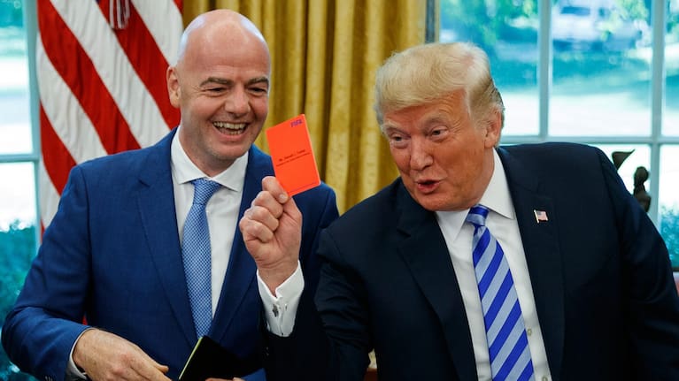 President Donald Trump holds up a red card during a meeting with FIFA president Gianni Infantino in the Oval Office of the White House in 2018.
