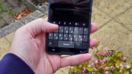 A person using the QWERTY Mini keyboard