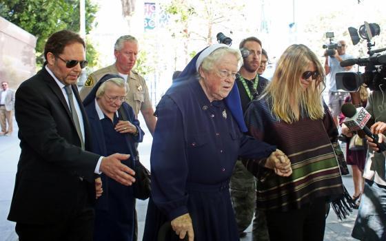 Srs. Catherine Rose Holzman, second left, and Rita Callanan, center, are escorted by businesswoman Dana Hollister, right, out of Los Angeles Superior Court (Photo: AP) Srs. Catherine Rose Holzman, second left, and Rita Callanan, center, are escorted by businesswoman Dana Hollister, right, out of Los Angeles Superior Court
