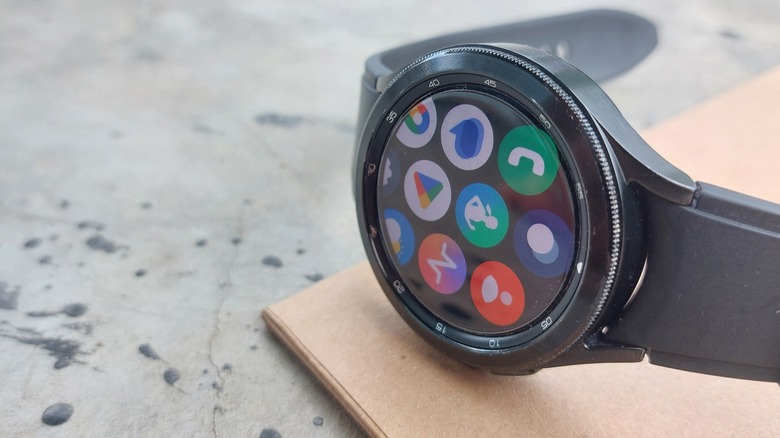 A Samsung Galaxy Watch sits on top of a piece of cardboard