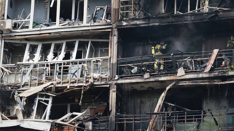 Rescuers work at the damaged apartment building following a Russian air guided bomb strike in Zaporizhzhia, Ukraine.