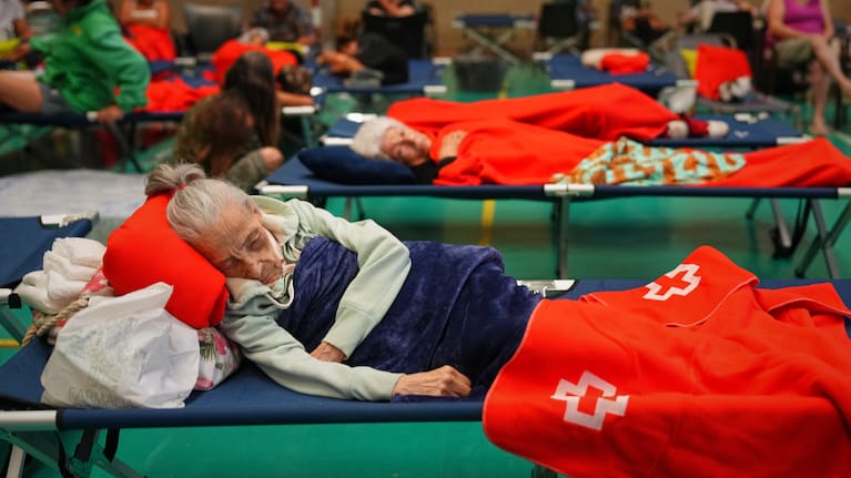 Residents spend the night at a sports center after being evacuated from their homes because of the threat of a wildfire in Cebreros, Ávila province, Spain, Friday, July 24, 2026