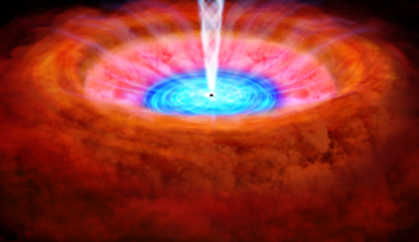 The accretion disk of NGC 4151 is shown in blue, immediately surrounding the galaxy’s central black hole. Scientists, including University of Michigan astronomers, are showing how winds or outflows from the accretion disk reshape its host galaxy. The winds are shown as wispy light blue lines blowing across the more orange clouds surrounding the black hole. Image credit: JAXA (Used under a CC BY 4.0 INT license)