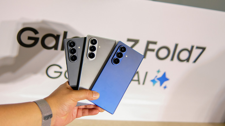 A person holding three colors of the Samsung Galaxy Z Fold7 during a launch event