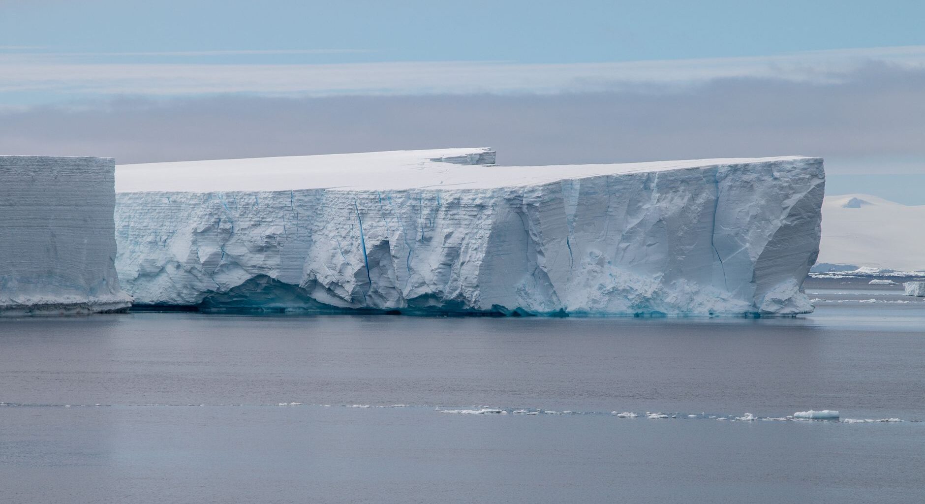Stunning view of a massive iceberg floating in the serene Antarctic waters.