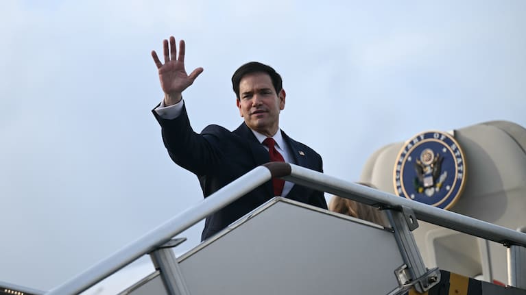 Secretary of State Marco Rubio waves from the top of the steps to his plane to depart at Ninoy Aquino International Airport in Manila, Philippines.