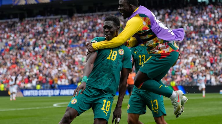 Senegal's Ismaila Sarr (18) is congratulated after scoring his side's 2nd goal during the World Cup round of 32 match between Belgium and Senegal in Seattle.